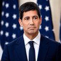 A man in a dark suit and tie stands in front of American flags, likely a politician or government official. The image pairs with a post about "$lunc" (Terra Luna Classic cryptocurrency), suggesting the figure's stance or statements have impacted or drawn criticism from the LUNC community.