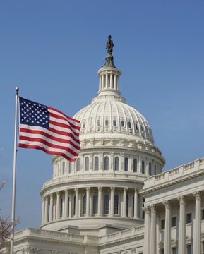 The U.S. Capitol dome stands beside a waving American flag, symbolizing the legislative branch where H.R. 3633—a new cryptocurrency bill aimed at clarifying regulatory uncertainties—was introduced by Republican senators.