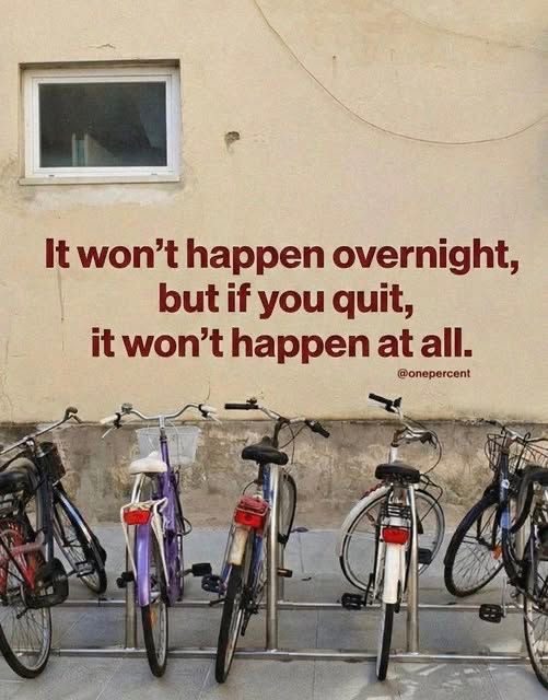 A photograph of bicycles parked against a beige wall featuring the text: 'It won't happen overnight, but if you quit, it won't happen at all. @onepercent'.