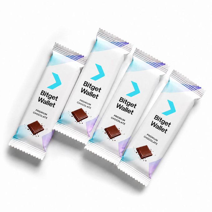 Four "Bitget Wallet Premium Chocolate" bars in white wrappers with blue and purple accents are arranged diagonally against a white background, visually punning on the concept of keeping chocolate in a wallet to illustrate tokenized commodities through the Bitget Wallet brand.
