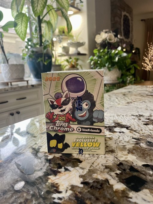 A 'VeeFriends Crypto Chrome' trading card box for 2023 sits on a granite countertop, advertising an 'Exclusive Yellow' Yerkers inside.