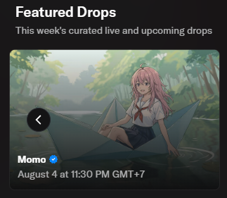 Featured Drops promotional card highlighting an upcoming NFT release by Momo (@momoyumemi), a verified creator, set for August 4 at 11:30 PM GMT+7, featuring anime-style artwork of a pink-haired girl sitting on a paper boat in a lush green forest setting. The hand-drawn art is by @cutemikaasa, with the minting timed to the creator's birthday.