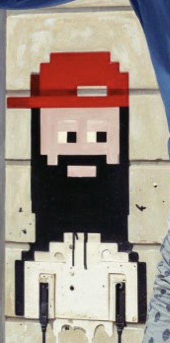 The image features a painting of a man with a beard, wearing a red hat, standing against a brick wall. The painting has been altered into a digital art piece by adding a watermark that reads "#WhateverBeeple @MillsxArt Reach for the sky to our loved ones past and present who were there at the right time - you mattered". This artwork is displayed on a poster or a canvas, with the man's face being the central focus. The painting has been altered in such a way that it appears as if the man is wearing a hat and standing against a brick wall, giving it an interesting and unique appearance.