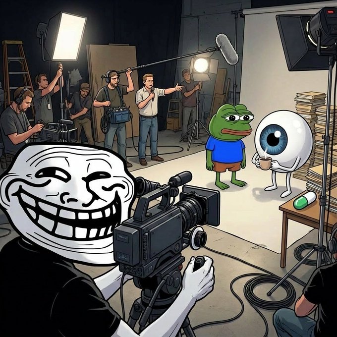 The image features a cartoon character holding a camera with a microphone attached to it, surrounded by several people who appear to be involved in the production of an animated series or movie scene. There are at least six people visible in the image, including the cartoon character, and they seem to be engaged in various activities related to filming. The presence of multiple people and equipment suggests that this is a professional setting where the creation process for the animated content takes place.