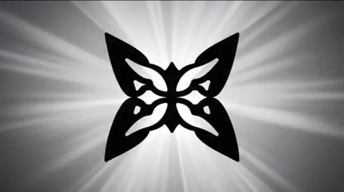 A black and white image showing a stylized butterfly mask or logo silhouette with light rays emanating from behind it.