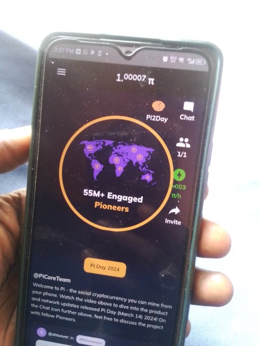 A hand holds a smartphone displaying the Pi Network app on "Pi Day 2024," showing a balance of 1.00007 π and a map highlighting "55M+ Engaged Pioneers," with an "Invite" button visible — reinforcing the post's message about inviting new users to expand the Pi Network community.
