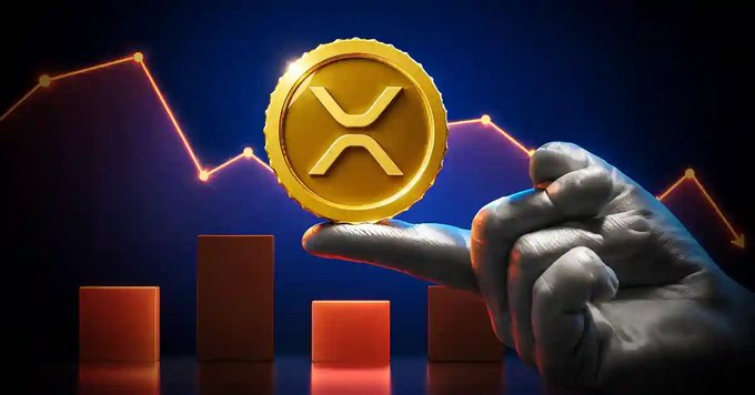 A digital illustration shows a hand holding a gold XRP (Ripple) coin, with a descending line graph and red bar charts in the background.