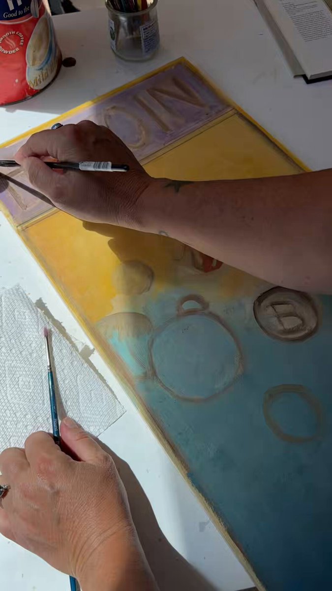 The image shows a person painting with a brush, using a combination of blue and white paint colors. The person's hands are holding the brush at an angle as they work on their artwork. The background features a table with various items such as a cup, a book, and a bottle. The post in the image is titled "CPC….CONVINCED….PEPE...CREATOOOORS" which suggests that the person painting might be using unconventional or unique colors for their art project.