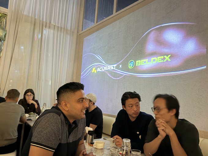 The image shows attendees engaged in conversation at the Beldex Private Dinner with Acurast in Seoul, with a backdrop displaying the "ACURAST x BELDEX" partnership logos.

In the foreground, three men sit at a table appearing to listen attentively, likely during the moment when BDXcris is "sharing a few words on Beldex's vision" as mentioned in the post, capturing the intimate networking atmosphere of the Web3 community gathering.