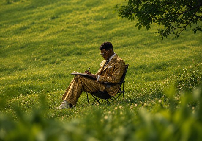 A man in a gold patterned suit sits in a folding chair on a lush green lawn, writing intently in a notebook beneath the shade of a tree—capturing the contemplative moment of planning a Web3 project from scratch.

The image visually echoes the post's prompt by evoking the image of an entrepreneur sketching ideas outdoors, turning a $10K investment into a vision for a real-world Web3 solution.