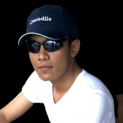 The image shows a man wearing a navy blue cap with "Crocodile" written on it, black sunglasses, and a white t-shirt against a dark background, identified by the post as @2000Rocker—a Pi Network community figure whom the post defends against criticism and credits with representing "the future of Pi."