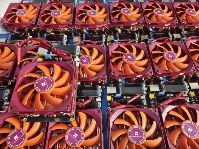 The image shows a large number of computer fans, specifically BM 1373 Solominer builds, arranged in rows with their orange color standing out against the background. The fans are spread across various positions within the frame, indicating that they have been placed there for assembly or testing purposes. This suggests that these fans might be in high demand due to their unique design and performance capabilities.