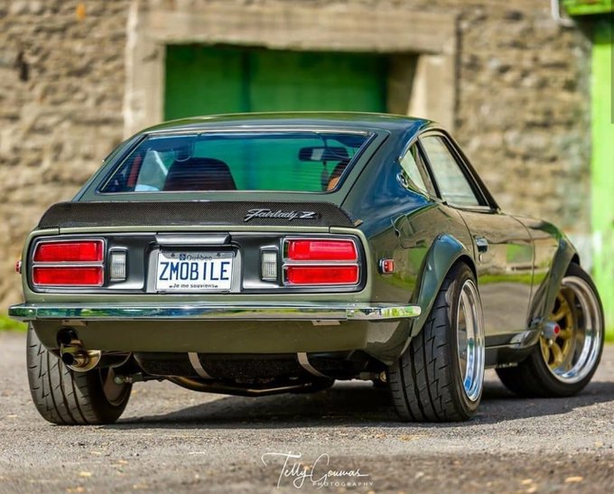 A customized olive-green Datsun 240Z "Fairlady Z" is parked on pavement, displaying a "ZMOB ILE" license plate and featuring gold deep-dish wheels. The image's emphasis on a restored, valuable classic car visually reinforces the post's reminder to "take profits," symbolizing the reward of a successful investment.