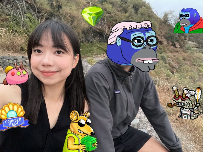 The image features two people posing for a picture with cartoon animal masks on their faces. The person on the left has a black dress and a pink hat, while the other person wears a gray jacket and glasses. They are surrounded by various cartoon animals such as a monkey, a lion, and an elephant. In addition to these characters, there is also a green diamond-shaped object in the image. The post includes text that reads "ronin monday selfie for the last few of us still alive in crypto ronin twitter i see ronke posts, axie, pixels, wild forest here and there, moku, og rats coming up hot".