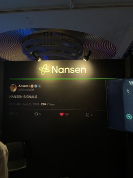 A photograph taken at an event shows a large display screen featuring the 'Nansen' logo, with a social media post titled 'NANSEN SIGNALS' dated '03:13 AM • Aug 21, 2025' showing 28K Views.