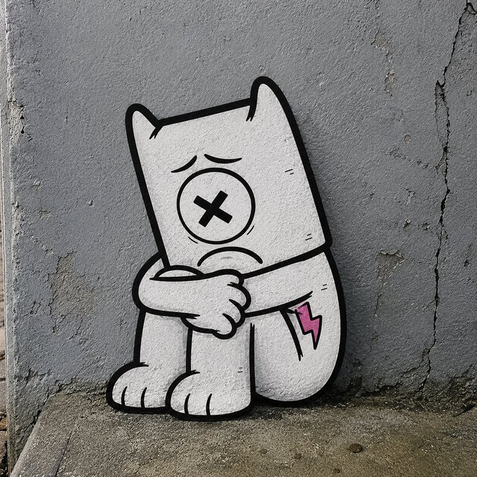 The image features a cartoon character sitting on a sidewalk, with a gray wall behind him. The character appears sad or distressed, possibly due to being painted over by someone who wanted to erase his presence. This act of erasing the character can be seen as an attempt to wash away any trace of the person's existence. The post about the graffiti artist suggests that this situation might have been a deliberate artistic choice rather than an act of vandalism or destruction, and it could potentially be used for educational purposes to discuss the impact of art on public spaces and the importance of respecting artists' work.