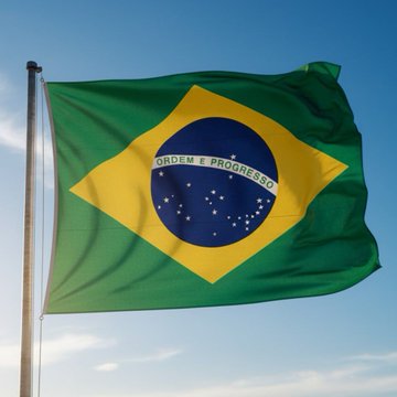 The national flag of Brazil waving against a blue sky with some clouds, featuring its characteristic green field, yellow rhombus, and blue circle with the motto 'ORDEM E PROGRESSO' over white stars.