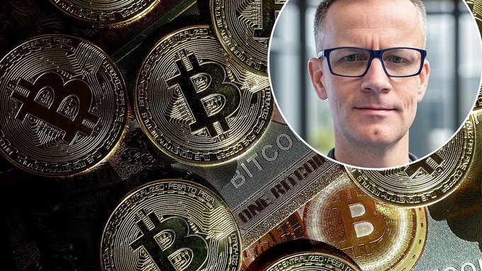 A photo of a man with glasses inset over an image of multiple gold-colored Bitcoin coins, with text reading 'BITCOIN' and 'ONE BITCOIN'.