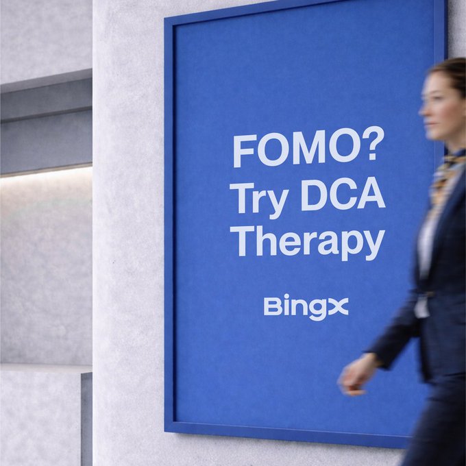 A woman walks past a blue BingX advertisement reading "FOMO? Try DCA Therapy," cleverly framing dollar-cost averaging as a cure for the fear of missing out in crypto markets.