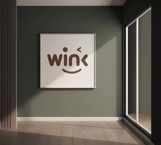 An interior room features olive green walls, wood-look flooring, and a framed artwork displaying the word 'wink' in brown text designed as a smiling face winking.