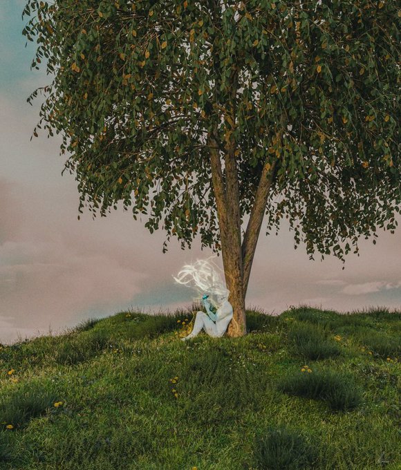 A person with flowing white hair sits peacefully at the base of a leafy tree on a grassy hill, reading a book against a backdrop of a pastel, cloudy sky.