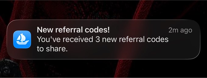 An iOS notification banner displaying "New referral codes! You've received 3 new referral codes to share" from the OpenSea app, which the post relates to by sharing referral codes WTRMWG and ZBF46E for others to use.