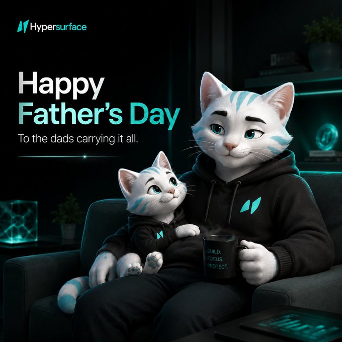 The image features a man sitting on a couch with two cartoon cats wearing hoodies. The text "Happy Father's Day" is displayed above them, and there are also some words related to fathers that appear below the cats. The background of the image shows a living room setting with a TV and a potted plant.