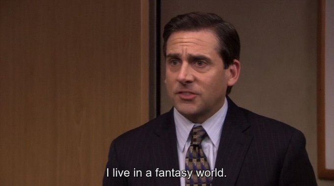 A man in a suit and tie stands in an office with wood-paneled walls, with a subtitle reading "I live in a fantasy world." The caption references a famous Michael Scott line from The Office, humorously connecting to a "$500,000,000,000" loan, suggesting the speaker is disconnected from financial reality.