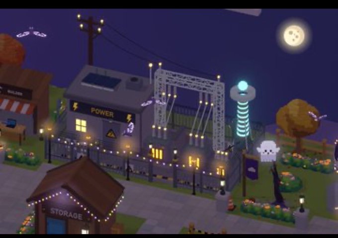 Video game screenshot (appears to be PowerWash Simulator) showing buildings labeled 'POWER' and 'STORAGE' at night with string lights, a full moon, and pumpkins in the surrounding yard.