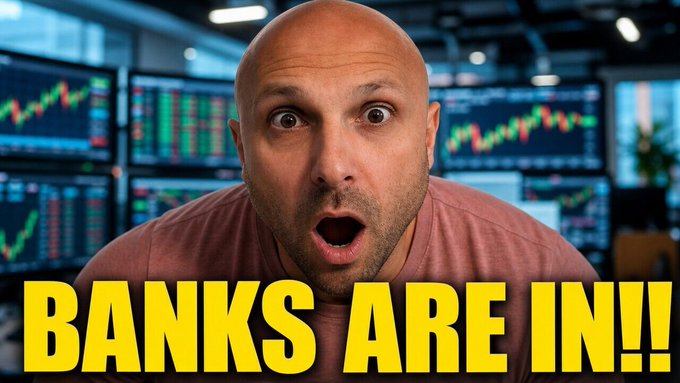 A bald man with a shocked expression stands in front of multiple screens displaying stock market charts and trading data, with bold yellow text reading "BANKS ARE IN!!" overlaid at the bottom. The image's excited tone and financial backdrop align with the post's bullish framing about XRP's scaling model and institutional relevance, suggesting significant banking adoption of the network.