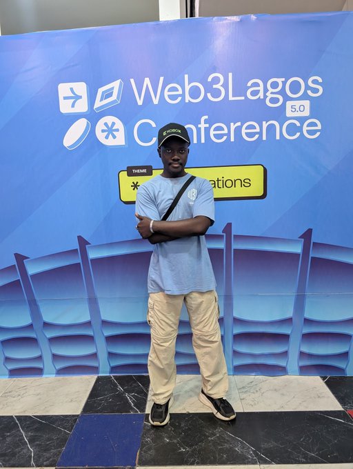 A young man wearing a cap and "KOBIX" t-shirt poses with crossed arms in front of the "Web3 Lagos 5.0 Conference" branded backdrop on day one of the event. The image captures the networking atmosphere mentioned in the post, as he represents Web3Unilag while promoting KoboxFinance to fellow attendees.