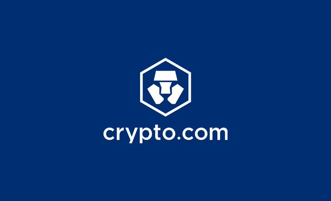 The image displays the Crypto.com logo, featuring a white hexagonal emblem with a stylized geometric design above the "crypto.com" wordmark, all set against a deep navy blue background. The logo relates to the accompanying post by representing the cryptocurrency company whose planned partnership with Trump Media has been terminated.