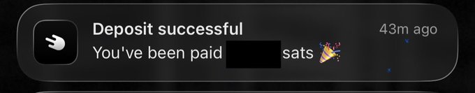 A mobile notification showing "Deposit successful - You've been paid [redacted] sats" with a celebratory party popper emoji, timestamped 43m ago, illustrating the pride of receiving a Bitcoin Lightning payment in satoshis rather than traditional fiat currency.