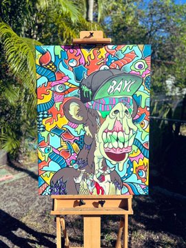 A vibrant Roc Sol original painting displayed on an outdoor easel features a colorful, psychedelic skull and ape character surrounded by intricate patterns, matching the artist's distinctive style mentioned in the commission announcement. The artwork includes a speech bubble reading "BAYC," tying it to the Bored Ape Yacht Club community referenced in the post.