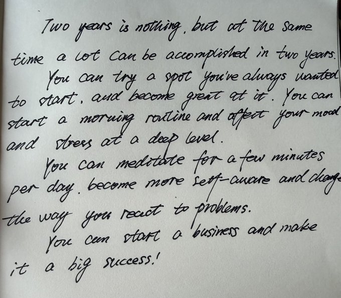 A handwritten note on white paper reading: 'Two years is nothing, but at the same time a lot can be accomplished in two years. You can try a sport you've always wanted to start, and become great at it. You can start a morning routine and affect your mood and stress at a deep level. You can meditate for a few minutes per day, become more self-aware and change the way you react to problems. You can start a business and make it a big success!'