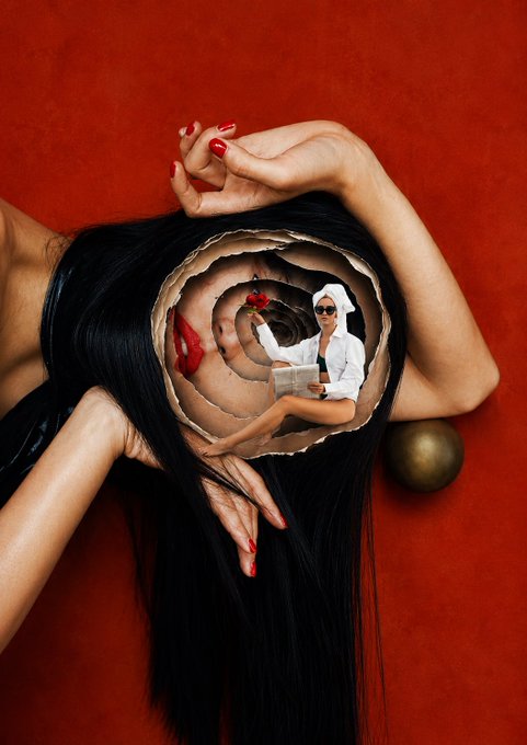 A surreal composite image featuring a woman with long black hair lying against a red background, with a spiraling tunnel carved into her head where another woman in a white shirt sits reading a book and holding a red apple.
