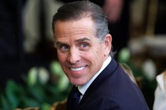 A smiling middle-aged man in a dark suit and tie is pictured in what appears to be a formal indoor setting, with the accompanying post referencing a notable figure's association with cryptocurrency.