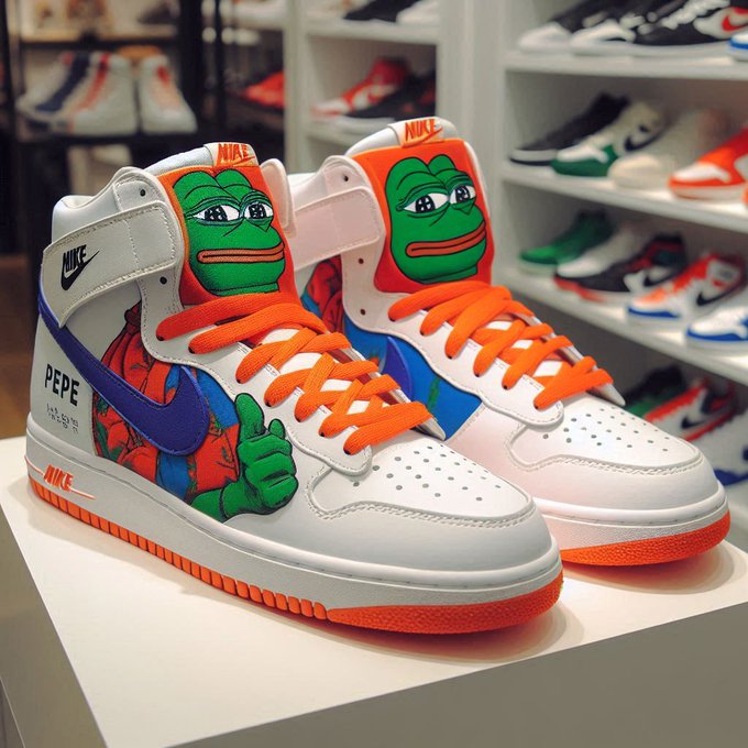 A pair of white Nike high-top sneakers featuring Pepe the Frog artwork on the side panels, orange laces, and a purple Nike swoosh displayed on a white table in a sneaker shop.