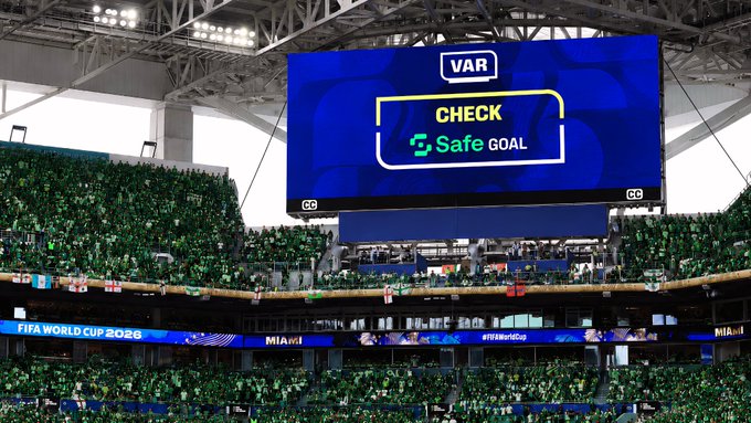 A stadium screen displays 'VAR CHECK' with a 'Safe GOAL' indication, while the ribbon board below shows 'FIFA WORLD CUP 2026' and 'MIAMI' as the crowd fills the stands.