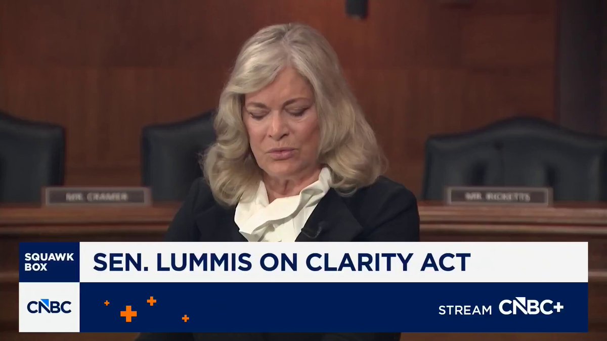 The image features a woman sitting at a desk with a microphone, likely participating in an interview or speaking event. The text overlaying the image reads "sen. lumis on clarity act stream cnbc just fired back at jameie dimon live on CNBC he is either hasn't read the bill, or wants to mislead people". This suggests that the woman might be discussing a recent news story about Sen Lumis and her stance on clarity acts, which could potentially impact the public's understanding of the issue.