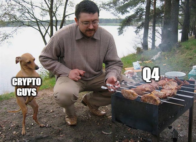 A meme featuring a man barbecuing meat on a grill while a scrawny dog labeled "CRYPTO GUYS" watches hungrily from the side, with the meat labeled "Q4"—suggesting that crypto enthusiasts have been waiting all quarter (Q4) for the "meal" of gains that never actually arrived. The juxtaposition of the eager, starving dog and the tempting but seemingly inaccessible food humorously captures the "Real" sentiment of crypto traders' patience and anticipation during a disappointing quarter.