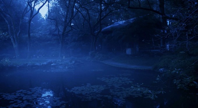 A moody, misty blue-toned nighttime forest scene with a small pond, water lilies, and a thatched-roof hut among the trees.