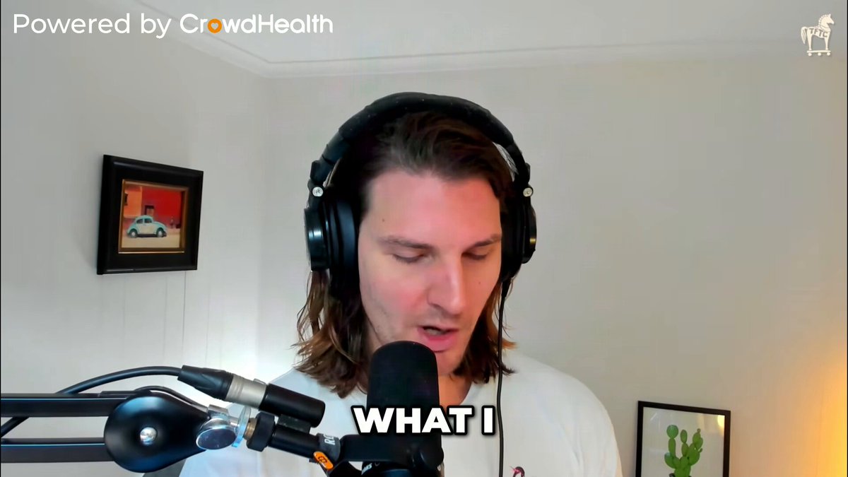 In this image, there's an older man wearing headphones who appears to be singing into a microphone. The man is surrounded by various objects that include a cactus plant, a car, and several paintings. Below him, there is text on social media platforms discussing cryptocurrency trends in relation to the stock market. One particular post titled "What I'm buying like a madman" mentions a meme about investing in Bitcoin at its lowest price, expressing excitement for potential profits despite the negative sentiment surrounding it. This post highlights how an individual's perception of a situation can be influenced by external factors and personal interests, even when those factors might not necessarily align with current market trends or conditions.