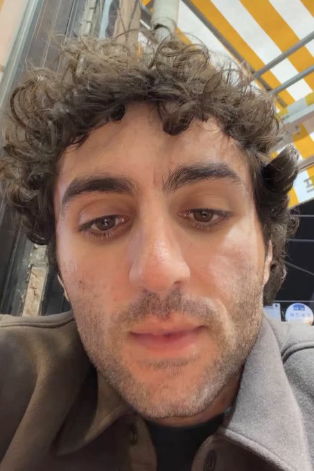 A curly-haired man takes a close-up selfie with a neutral expression, likely the crypto trader "Rasmr" who just announced his bullish flip on $PUMP coin, praising PumpFun's impressive run.