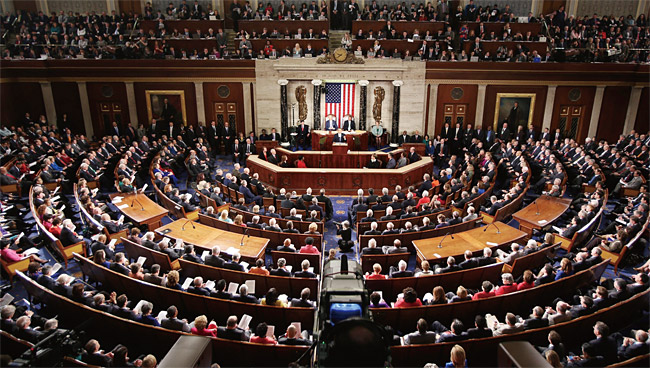 The image shows a packed U.S. House of Representatives chamber during a joint session of Congress, with an American flag and the Speaker's rostrum visible at the front, filled with hundreds of lawmakers and onlookers. This relates to the post's description of legislative chaos, specifically a Senate cloture vote on the CLARITY Act on September 15th at 2:15 PM, where 60 votes were needed while the House was preparing to adjourn on September 17th after leadership cuts on September 3rd.