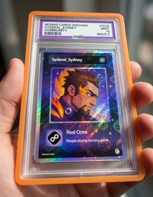 Hand holding a graded 'Monad Cards Onchain' slab featuring the 'Syderal_Sydney' community card, #1026, Mint 10, Wave C, with 'Real Ones' branding.