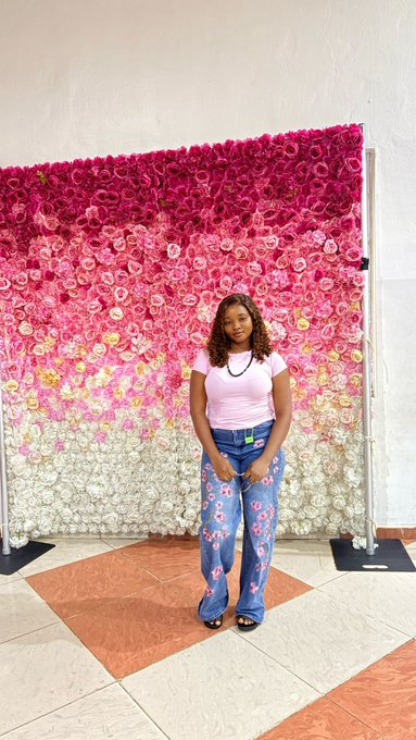 A woman wearing a pink top and floral blue jeans stands smiling in front of a vibrant pink and white floral backdrop, promoting the final day of free registration for the Fluxzone Web3 Bootcamp Cohort 3.