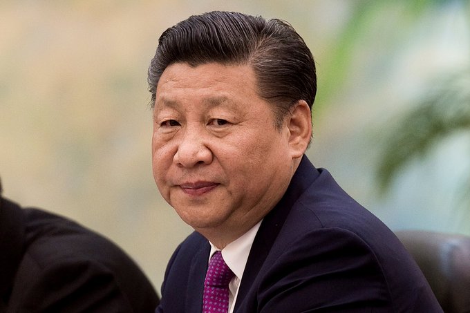 A portrait of Xi Jinping, President of China, is shown, relevant to the news that China is closing 670 rural banks due to economic slowdown.