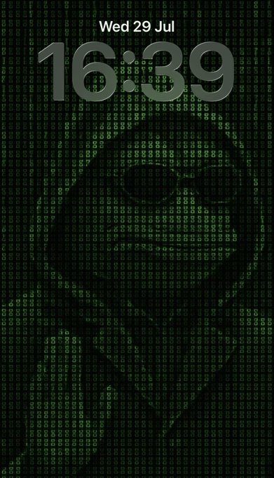 A phone lock screen displaying "Wed 29 Jul" and the time "16:39" set against a green Matrix-style digital rain background featuring a faint silhouette of a cat.
