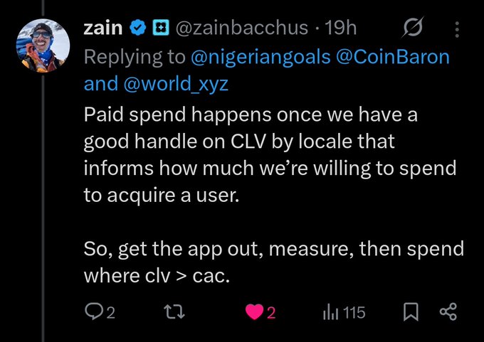 A tweet from @zain (zainbacchus) explaining that paid user acquisition spending will begin once they have a clear understanding of Customer Lifetime Value (CLV) by locale, advising to "get the app out, measure, then spend where clv > cac." The tweet replies to @nigeriangoals, @CoinBaron, and @world_xyz, and has 115 views and 2 likes, supporting the accompanying post's theme of leadership engaging with the community about Crypto.com's growth strategy.